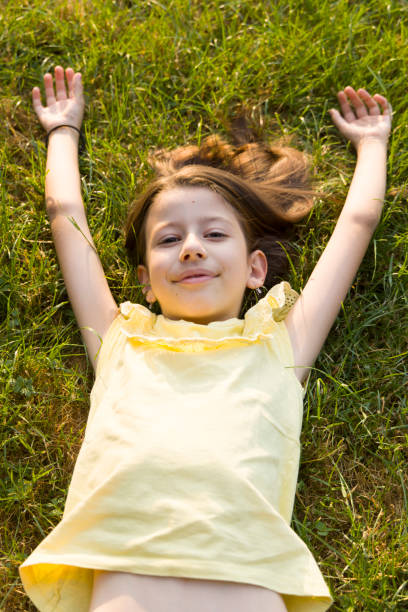 Happy girl on green grass stock photo