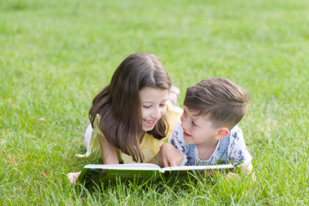 Kids reading book stock photo