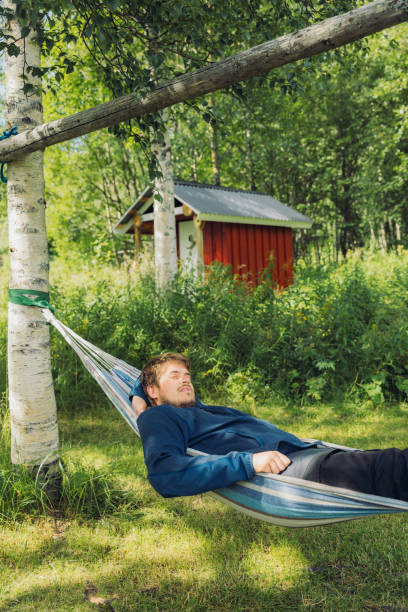istock Happy man relaxing on hammock in summer Norwegian forest 1501114454