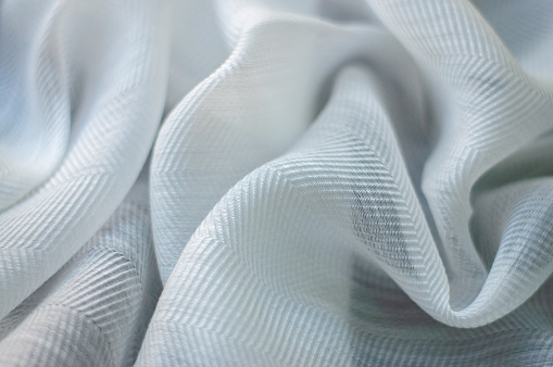 Natural Gauze fabric. Wrinkled gray fabric background. Closeup