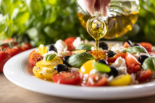 Caprese salad is oiled with olive oil.