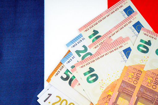 Stack of euro banknotes on the green background