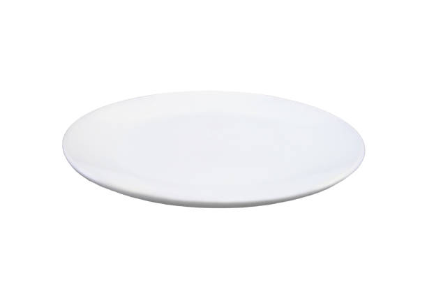 istock Concept with an empty plate in a modern kitchen, isolated on a white background. Copy space plate for food 1501129550
