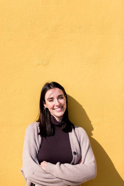istock woman smiling looking at camera with arms crossed 1501130196