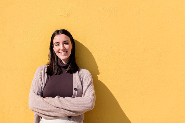 istock woman smiling looking at camera with arms crossed 1501130198