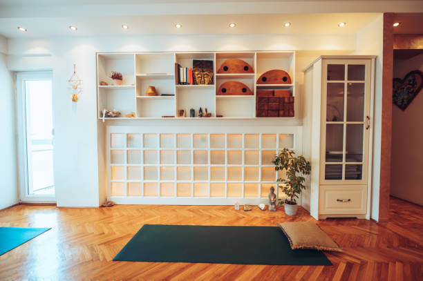 istock Shelf on the wall with yoga equipment while below is a long mosaic window. 1501130678
