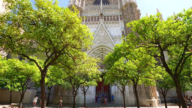 Tourists visit Catedral de Sevilla in the historic old town area of Seville in the southern Andalusian region of Spain