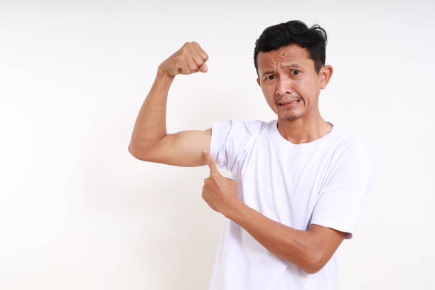 Asian funny man pointing his arm with strong gesture. Isolated on white