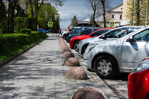 Cars parked in a row on the street of the city.