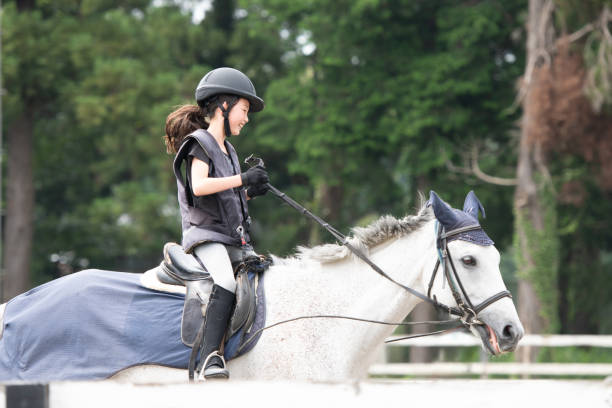 Girl practicing horse riding on a rainy day