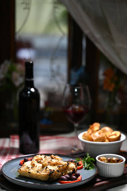 typical portuguese dish roasted codfish with onion garlic peppers and rustic babata lusitanian food