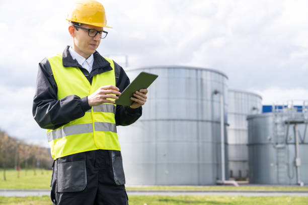 istock Engineer on a background of gas tanks 1501147934