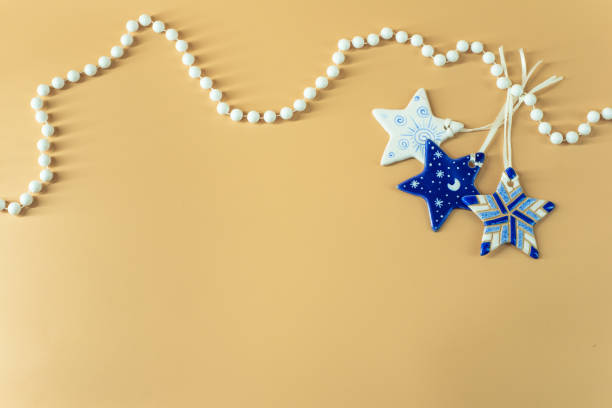 istock New Year blue stars with white beads on beige background 1501148268