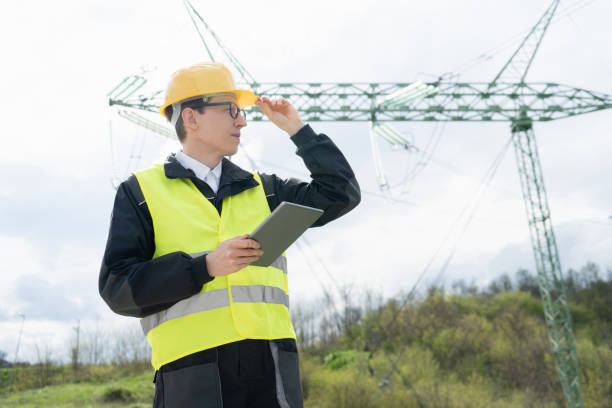 istock Engineer on a background of power line tower. 1501148345