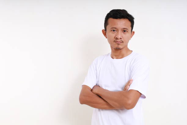 istock Asian funny man standing with folded hands. Isolated on white background 1501152710