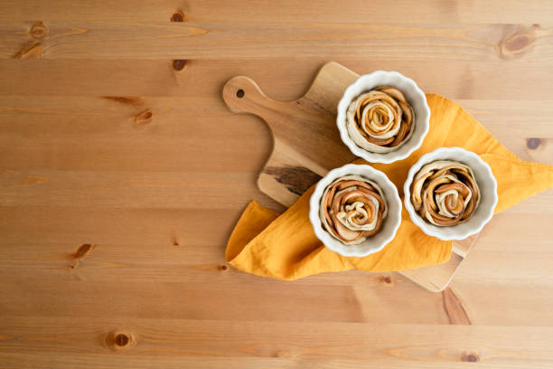 Homemade cinnamon and apple rolls on a wooden table