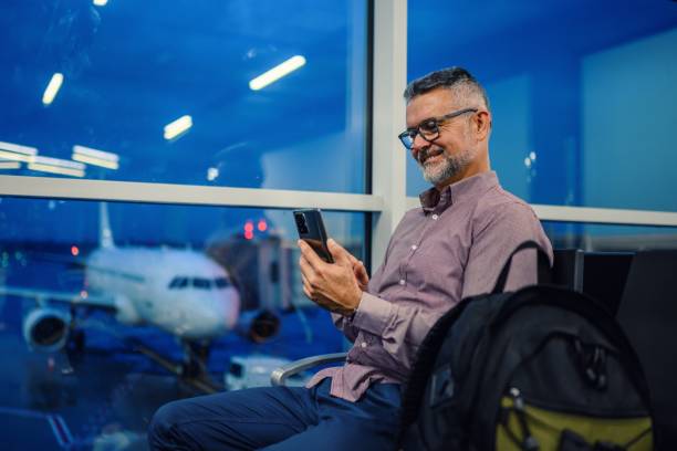 istock Man waiting for his flight in airport lounge 1501156651