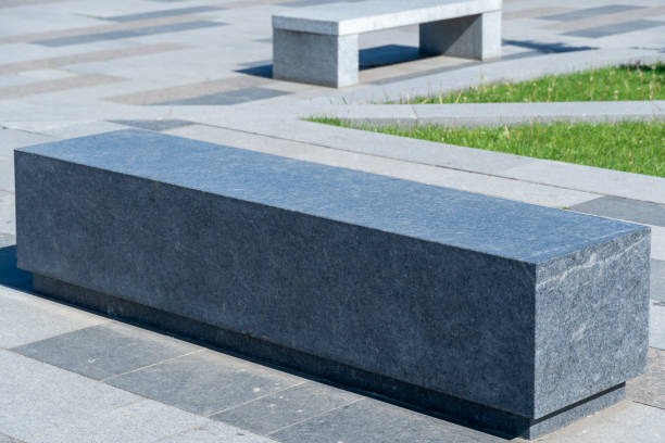 istock Comfortable stone bench in city park. 1501160067
