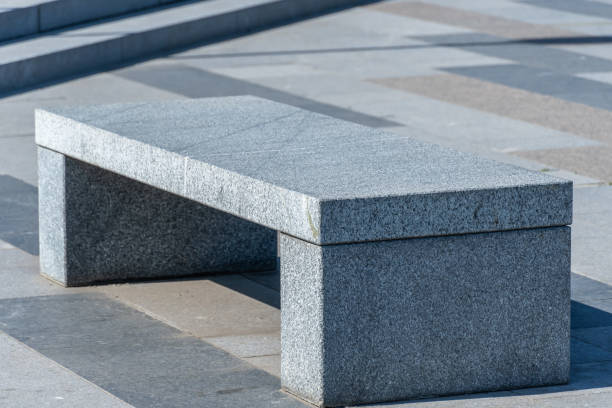 istock Comfortable stone bench in city park. 1501160125