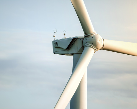 Close up of industrial wind turbine against sky background