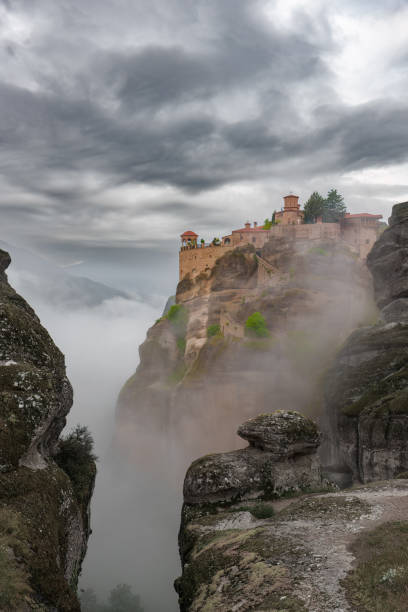 istock Meteora monastery complex, Greece. Orthodox monastery on the rock, emerging from morning mist. UNESCO site, Greece. 1501166052