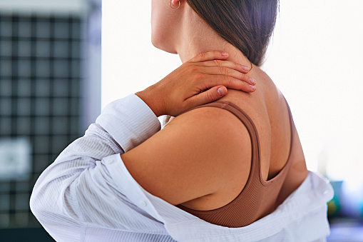 Close up of painful unwell unhealthy woman suffering from pinched inflammation nerve and neck pain. Health problems