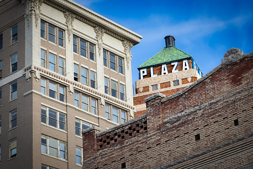 El Paso, Texas, USA - June 6, 2023: The Plaza Hotel, in the downtown area, seen from behind surrounding buildings.