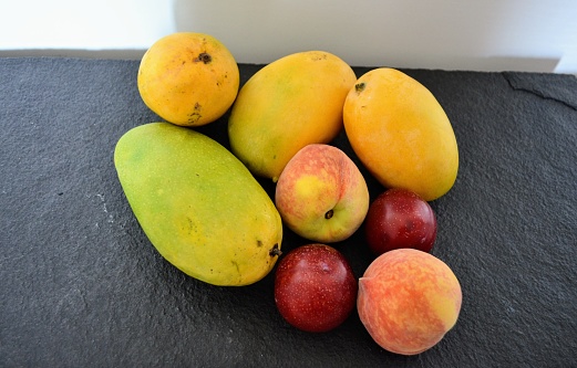 Fresh, healthy fruits mangoes, peaches and plums. Delicious food healthy lifestyle. Season colourful ripe and ready to eat.