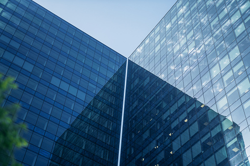 Low angle view of modern office buildings at night, New York City, USA