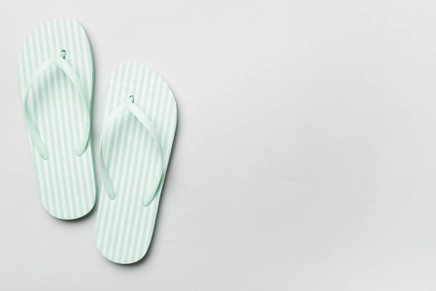 istock Striped flip flops on color background, top view 1501184182