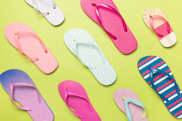 istock Many colorful flip flops on color background, top view 1501184186