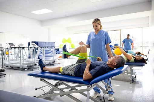 Man doing physical therapy exercises using a stretch band