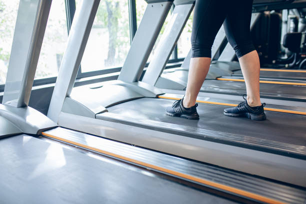 istock Young woman using the treadmill in the gym 1501190454