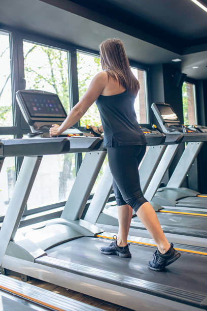 istock Young woman using the treadmill in the gym 1501190504