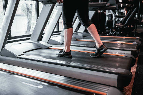 istock Young woman using the treadmill in the gym 1501191156