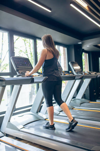 istock Young woman using the treadmill in the gym 1501191279