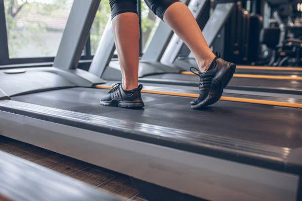 Young woman using the treadmill in the gym
