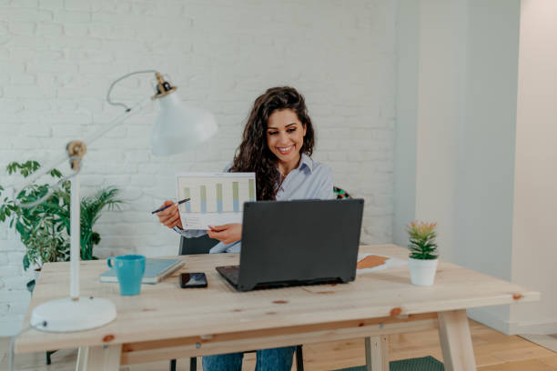 istock Woman cheerfully holding up a graph 1501192681