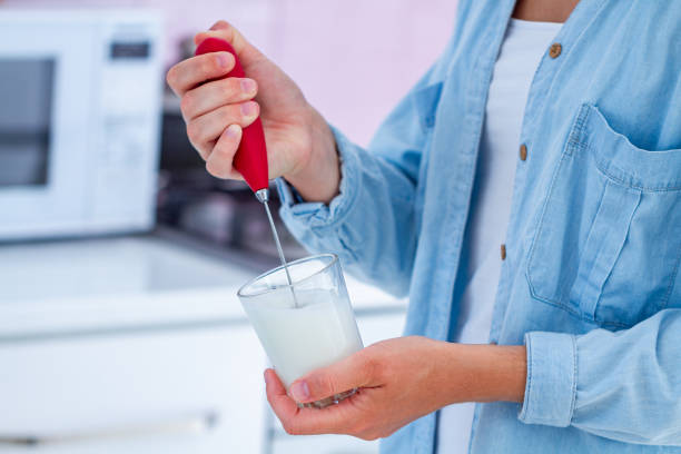 istock Housewife making aromatic cappuccino with a frother at  kitchen 1501193162