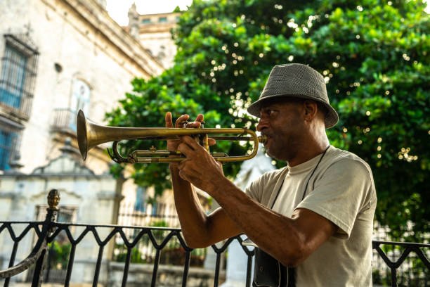 Mature man playing the trumpet on the streets of Havana, Cuba