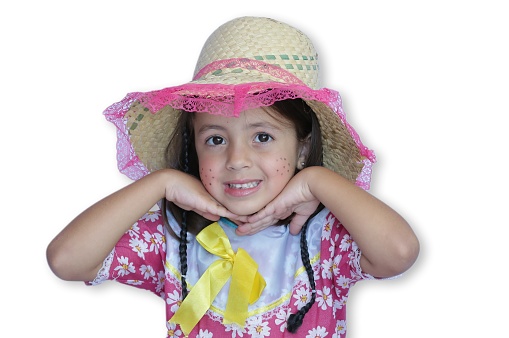 beautiful child in party outfit with hat and white background.
