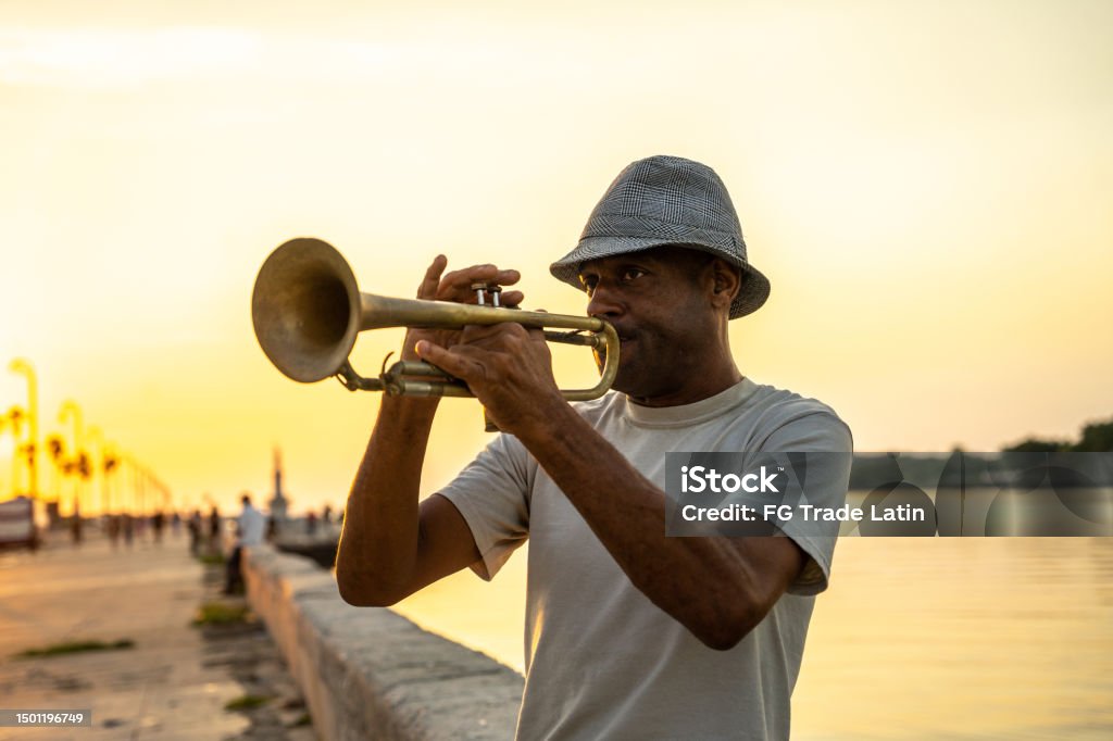 Mature man playing the trumpet on the streets of Havana, Cuba Latin American and Hispanic Ethnicity Stock Photo