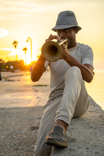 Bearded man playing a saxophone isolated on white background