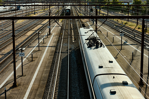 Train arriving at station and one leaving. High angle view.