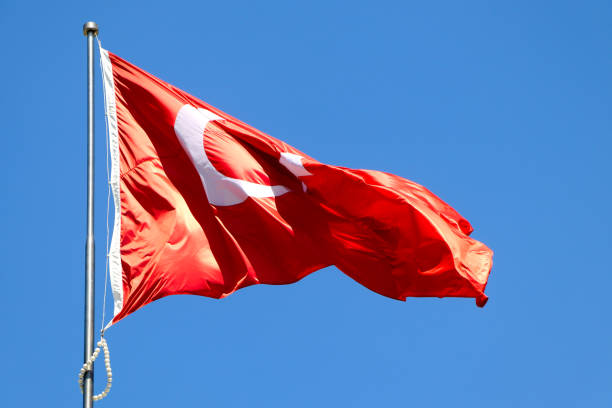 istock Waving Turkish flag. Sky background. Flag with star and crescent symbol 1501202720