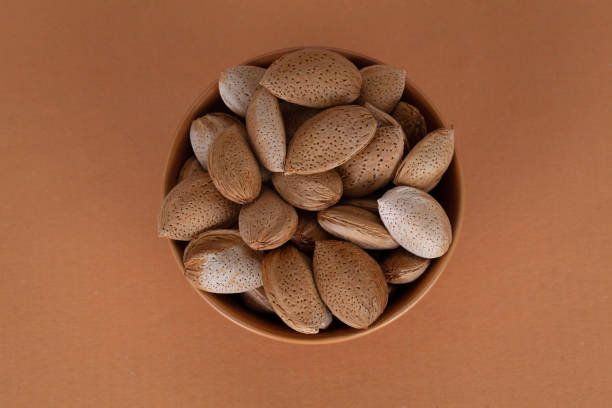 shelled almonds in brown bowl
