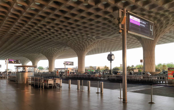 11th April 2023 - Mumbai, India: The drop-off area outside the Terminal 2 of Chhatrapati Shivaji International Airport. The current T2 opened in 2014 and was designed by SOM. The iconic pillars and coffered canopy with recessed lights reflect both the airiness of a traditional Indian pavilion and the Peacock.