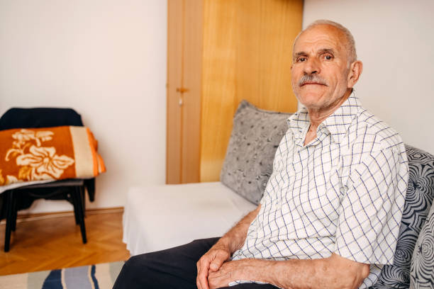 istock Old man spending time home alone sitting on sofa bed 1501203318