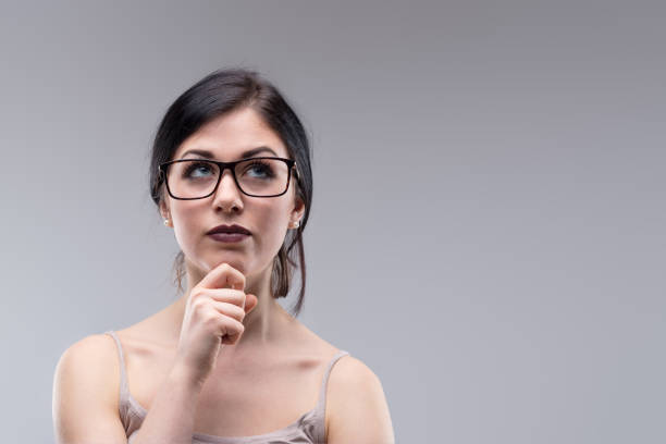 istock Attractive woman in glasses deep in thought 1501205534
