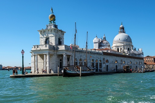 Venice, Italy – September 19, 2022: A stunning view of Punta della Dogana in Italy, with crystal clear blue waters